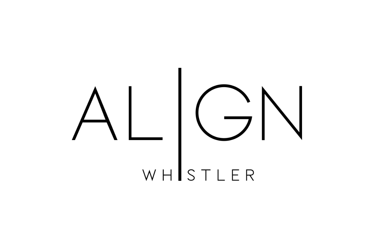 Skier riding down mountain on a sunny day blue skies and fresh powder kicking up behind