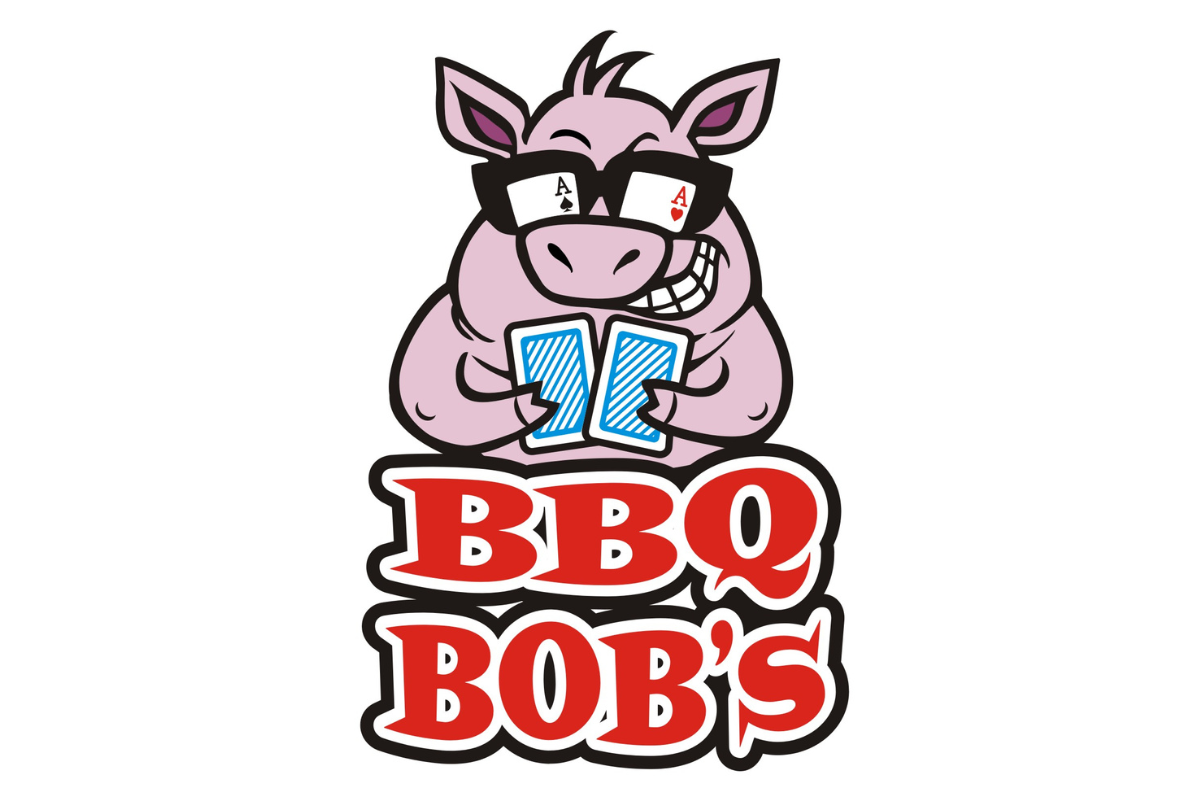 Skier riding down mountain on a sunny day blue skies and fresh powder kicking up behind