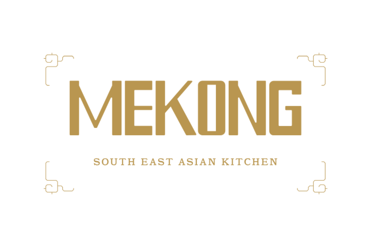 Skier riding down mountain on a sunny day blue skies and fresh powder kicking up behind