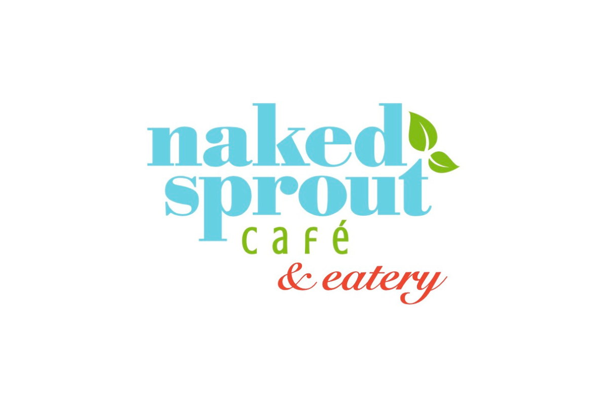 Skier riding down mountain on a sunny day blue skies and fresh powder kicking up behind