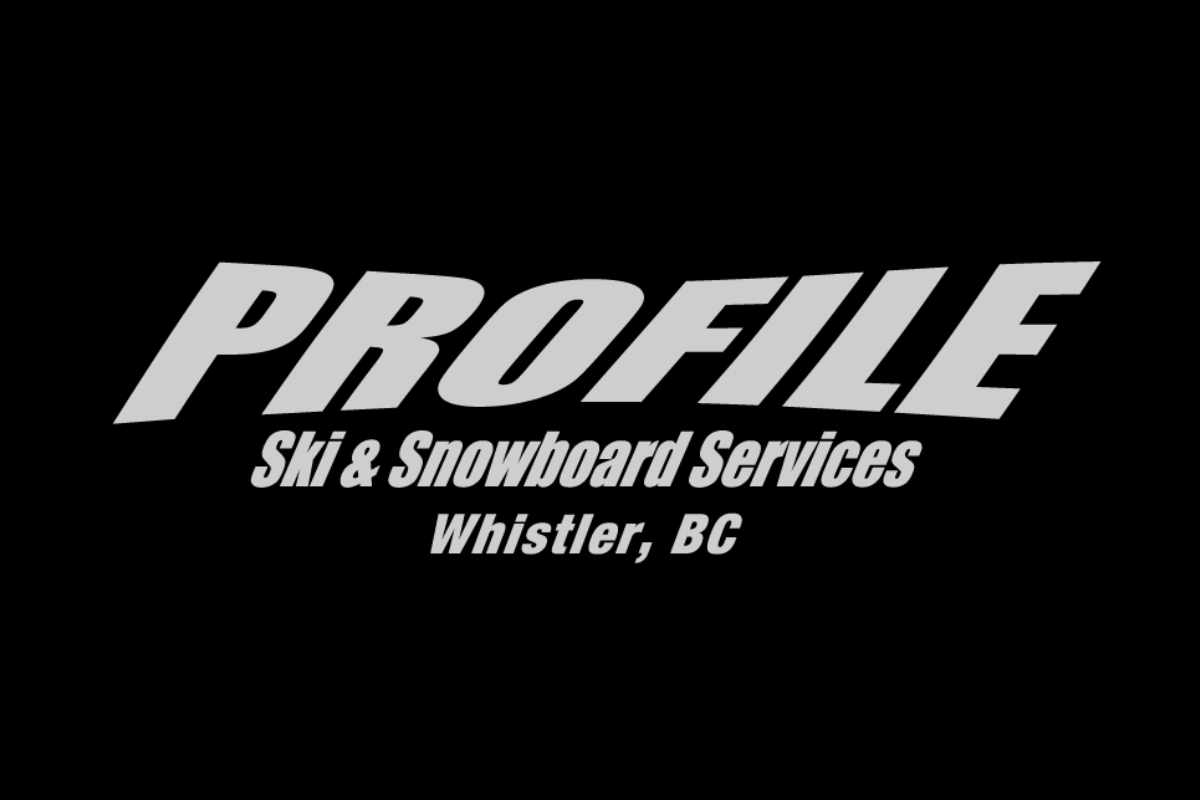 Skier riding down mountain on a sunny day blue skies and fresh powder kicking up behind