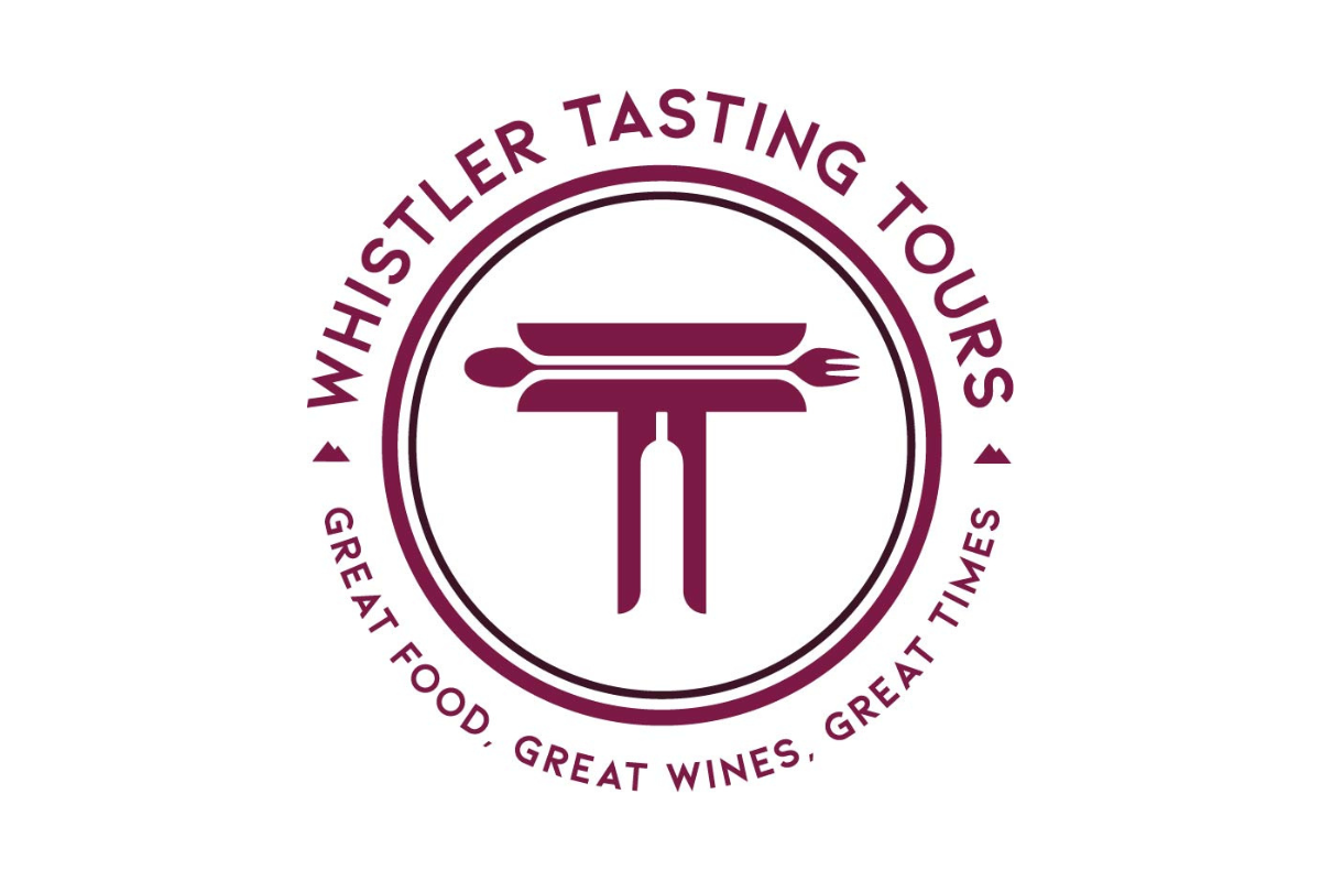 Skier riding down mountain on a sunny day blue skies and fresh powder kicking up behind