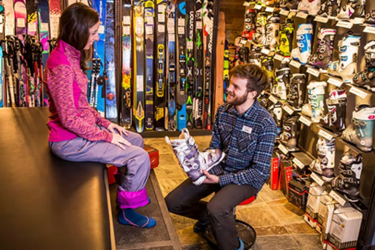 retail image Skier riding down mountain on a sunny day blue skies and fresh powder kicking up behind